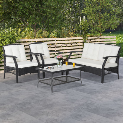 "Outdoor Oasis: 4-Piece Rattan Patio Set with Coffee Table and Cushions"